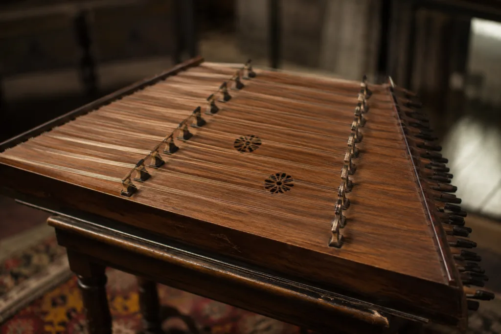 Santur, a traditional Persian hammered dulcimer, with a trapezoidal wooden frame and strings played with small mallets.